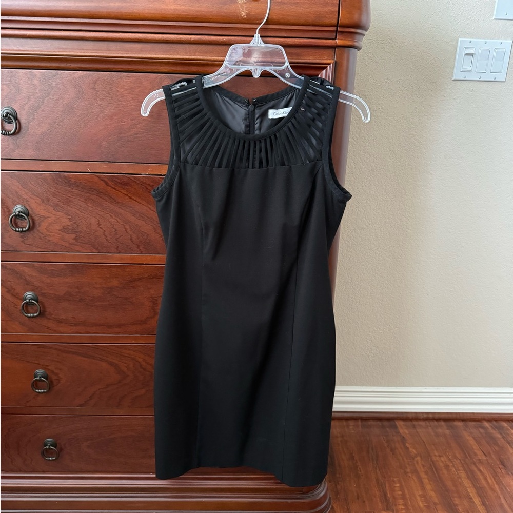 Calvin Klein black dress with cute front yoke slits.  Size 6.
